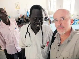  ?? Samaritan’s Purse/for the Calgary Herald ?? Mabior Nyuong Bior, centre, a Sudan-born doctor who returned to his South Sudan homeland and dodged militia bullets recently, is seen with John Clayton, Samaritan’s Purse Canada’s programs director.