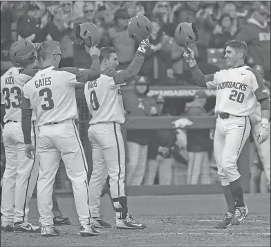  ?? Craven Whitlow/Special to the News-Times ?? Greeting at home plate: Arkansas' Carson Shaddy is greeted at home plate after hitting a three-run homer in the Razorbacks' 14-2 win over Bucknell in their season opener on Friday afternoon.