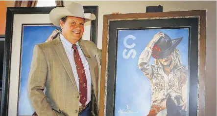  ?? AL CHAREST ?? Calgary Stampede chairman and president Dana Peers shows off the 2019 Calgary Stampede poster.
