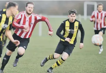  ??  ?? Sunderland West End (red) fight it out with Hebburn Town Reserves last week. Picture by Tim Richardson