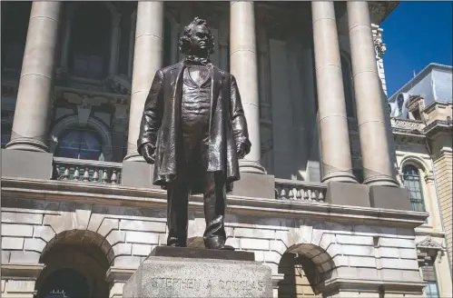  ?? (The State Journal-Register/Justin L. Fowler) ?? A statue of Stephen Douglas stands in front of the east entrance to the Illinois State Capitol in Springfiel­d, Ill. Illinois officials approved the removal of the statue of the 19th century senator from Illinois who owned slaves and espoused the notion each territory should decide whether slavery would be allowed.