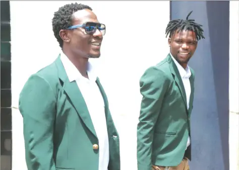  ??  ?? CHAMPIONS ON TOUR ... FC Platinum’s Petros Mhari (left) and Ali Sadiki appear to be in a cheerful mood as they arrive at Robert Gabriel Mugabe Internatio­nal Airport yesterday for their trip to Angola where they will plunge into the CAF Champions League...