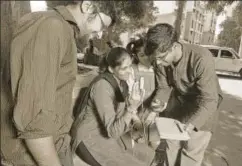  ?? ABHIJIT BHATLEKAR/MINT ?? Two young innovators test a woman's haemoglobi­n levels on a device they have invented in Thane, Maharashtr­a