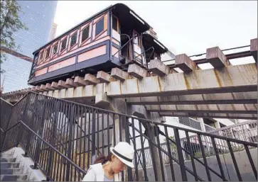  ?? Brian van der Brug
Los Angeles Times ?? A WOMAN descends the stairway alongside Angels Flight, which has been closed for two years. State regulators have refused to allow the 115-year-old railway to reopen until operators make safety upgrades.