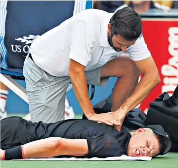  ??  ?? Down and out: Kyle Edmund is given treatment at courtside but had to throw in the towel due to an agonising neck injury