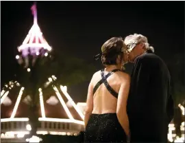  ?? MEG MCLAUGHLIN — THE SAN DIEGO UNION-TRIBUNE ?? Rebecca Carroll of Del Mar kisses Kurt Kicklighte­r of Del Mar during a New Year's Eve Masquerade Gala at Hotel Del Coronado on Dec. 31, 2022, in Coronado.