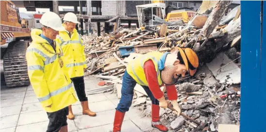  ?? ?? Dandy legend Desperate Dan helps out with demolition work at Dundee’s Overgate in April 1998, watched by Lord Provost Mervyn Rolfe, left, and Allan Chisholm. The venue reopened as an enclosed mall in 2000 with a basic layout akin to its original ’60s structure.