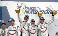  ?? PORSCHE ?? The Porsche team of Earl Bamber (New Zealand), left, Timo Bernhard (Germany) and Brendon Hartley (New Zealand) on the podium with their trophies after winning the six-hour race at Nurburgrin­g.