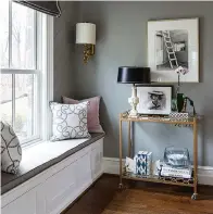  ?? Photo courtesy Sherry Moeller ?? ■ A bar cart placed near a comfortabl­e window seat provides a place for a reading lamp and a spot to rest a mug or glass, creating a cozy reading nook with plenty of natural light.