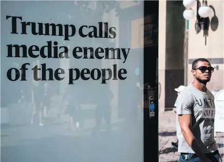  ?? JONATHAN NACKSTRAND/GETTY IMAGES ?? A man walks past an advertisin­g board reading “Trump calls media enemy of the people” on the day in July when the U.S. and Russian presidents held a private meeting in Helsinki, Finland. The billboard is one of hundreds sponsored by a Helsinki newspaper.