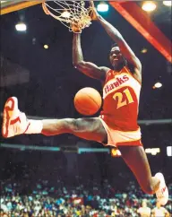  ?? Charles Cherney / Associated Press ?? The Bulls’ Michael Jordan, left, and Hawks’ Dominique Wilkins dunk during the slam-dunk competitio­n of the 1988 NBA All-Star weekend in Chicago. Jordan left the old Chicago Stadium that night with the trophy. To this day, many believe Wilkins was the rightful winner.