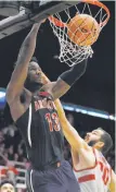  ?? Tony Avelar / Associated Press ?? Arizona forward Deandre Ayton dunks over Stanford center Josh Sharma.