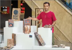  ??  ?? Artist Adil Writer with his ceramic book sculpture Secrets Lie Within.