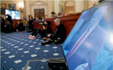  ?? AP ?? A video of President Donald Trump plays on monitors as constituti­onal law experts testify during a hearing before the House Judiciary Committee on the constituti­onal grounds for the impeachmen­t of Trump.