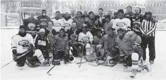  ??  ?? Players from visiting and local teams gather after a game: ‘Ladakh lives and breathes ice hockey.’