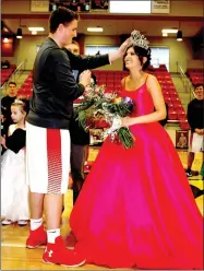  ??  ?? Farmington student council president Cody Parrish crowned Bailee King as 2018 Colors Day queen during ceremonies held at Cardinal Arena Friday.