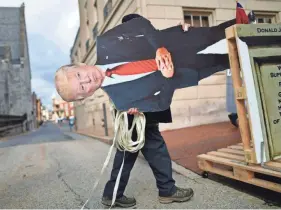  ?? MARK MAKELA/GETTY IMAGES ?? A Donald Trump effigy is wheeled to a protest in Harrisburg, Pa., on Sunday. Facebook says it is watching for “signals of violence.”