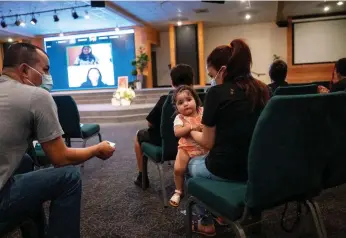  ?? Lezlie Sterling/the Sacramento Bee ?? Cristobal and Lorena Aleman sit with one-year-old baby Mia Lopez in a Sacramento ACT town hall meeting centered around community schools at South Sacramento Christian Center on April 12.