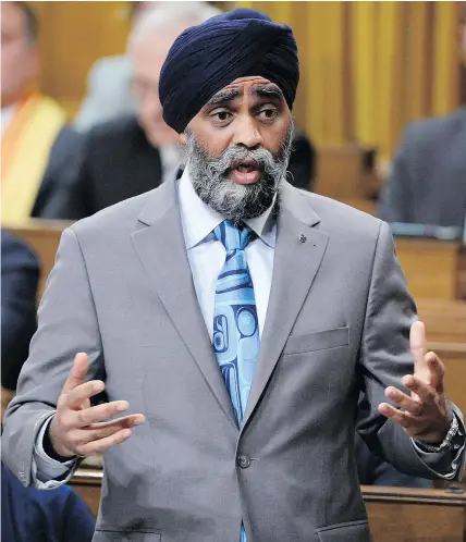  ?? — THE CANADIAN PRESS ?? Defence Minister Harjit Sajjan responds to a pounding from the opposition over his statements about his war record during question period in the House of Commons Monday.
