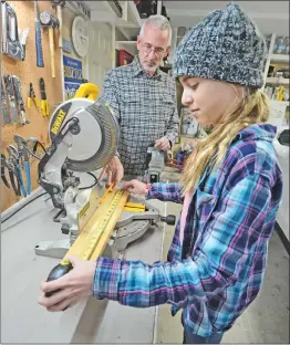  ?? Dan Watson/For the Signal ?? Bob Dodge instructs his granddaugh­ter Jenna Espinoza, 13, as they work on wood working projects together in Bob’s garage.