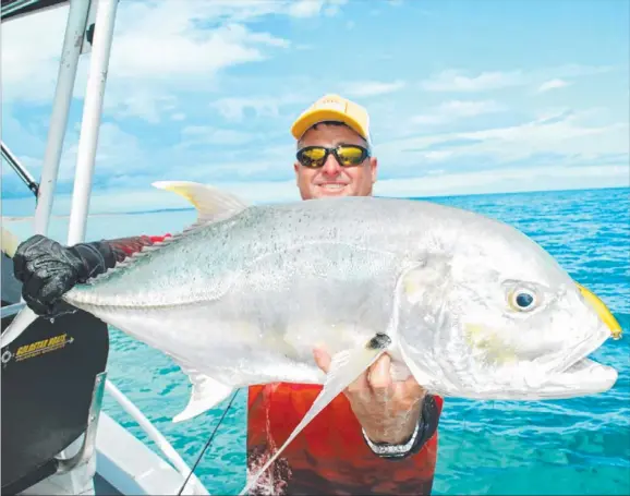  ??  ?? Craig Wallace with a stonkin’ trevally, caught with Terence ‘Bomber’ Farrell in the remote waters of Groote Eylandt