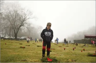  ?? LAUREN A. LITTLE — MEDIANEWS GROUP ?? Ben Wright, 12, of Exeter, was among the volunteers Dec. 14 during Wreaths Across America at Forest Hills Memorial Park in Exeter Township.