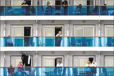  ?? Noah Berger Associated Press ?? PASSENGERS aboard the Grand Princess look out from their balconies as the cruise ship settled into a holding pattern on Sunday about 25 miles off the San Francisco coast. The ship docked on Monday in Oakland.