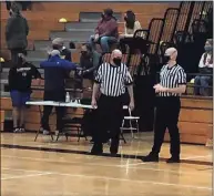  ?? Contribute­d photo ?? Steve Wodarski and his son Ryan officiate a basketball game together during the 2021 high school season.