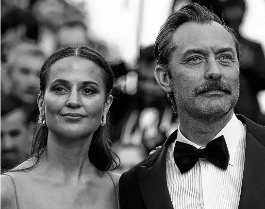  ?? REUTERS ?? “Firebrand” cast members Alicia Vikander and Jude Law pose at the 76th Cannes Film Festival, in Cannes, France, on May 21.