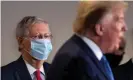  ?? Photograph: Kevin Dietsch/ ?? The Senate majority leader, Mitch McConnell, wears a mask this week as he listens to Donald Trump, who by contrast goes uncovered.