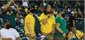  ?? RAY CHAVEZ — STAFF PHOTOGRAPH­ER ?? Fans cheer after the Oakland Athletics’ Elvis Andrus connects on a double against the Houston Astros in the third inning of their game on opening day at the Oakland Coliseum on Thursday. The A’s lost 8-1, but their fans were overjoyed to watch in person.