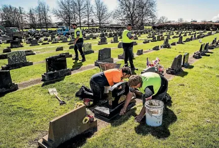  ?? BRADEN FASTIER/NELSON MAIL ?? G Miller & Son workers restore vandalised head stones at Richmond Cemetery after a weekend of incidents where headstones were pushed over and broken.