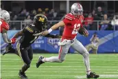  ?? AP ?? Ohio State quarterbac­k Lincoln Kienholz, forced to play after starter Devin Brown suffered a first-quarter high ankle sprain, runs from Missouri linebacker Triston Newson in the second half of Friday’s Cotton Bowl.