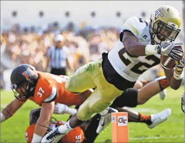  ?? David Goldman/AP ?? Georgia Tech’s Clinton Lynch, right, dives but comes up short of the goal post while running the ball past Mercer’s Tyler Ward, left, in the second half of an NCAA college football game in Atlanta, Saturday, Sept. 10, 2016.