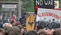  ?? (AFP) ?? Demonstrat­ors hold placards as they take part in the so-called “Revolution­ary Mayday” demonstrat­ion in Berlin’s Neukoelln district on Sunday.