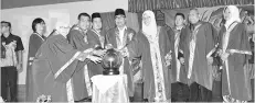  ??  ?? Yahya (fourth left) and Joharah (front, right) performing the opening gimmick at the SMK Putatan student excellence award ceremony yesterday.