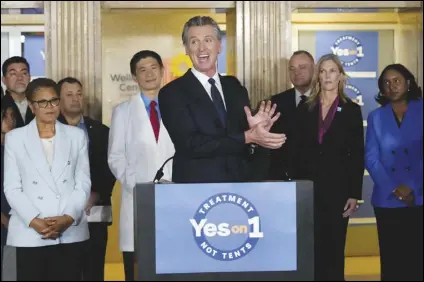  ?? ASSOCIATED PRESS FILES ?? California Gov. Gavin Newsom speaks in support of Propositio­n 1, a $6.38 billion bond ballot measure, during a January news conference at the Los Angeles General Medical Center in Los Angeles. California voters have passed the measure, which will impose strict requiremen­ts on counties to spend on housing and drug treatment programs to tackle the state’s homelessne­ss crisis. At left is Los Angeles Mayor Karen Bass.