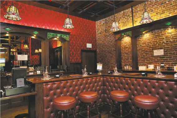  ?? Photos by Liz Hafalia / The Chronicle ?? The Barbary Coast lounge is divided into two rooms: the glass-walled vapor bar and a larger room where cannabis smoking is allowed. The rooms are unified by stained-glass chandelier­s and dark wood finishes.