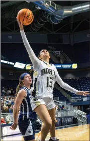  ?? ?? Left: North Kingstown’s Jaelyn Holmes drives past Moses Brown’s Lauren Bousquet during Saturday’s game at The Ryan Center.