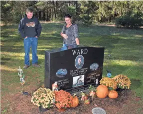  ?? MARK KONEZNY/USA TODAY SPORTS ?? Pamela and Kevin Ward Sr. stand last month at the grave of Kevin Ward Jr., who died during a dirt-track race on Aug. 9, 2014.