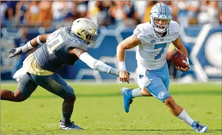  ?? KEVIN C. COX / GETTY IMAGES ?? North Carolina’s Sam Howell leads the ACC with 20 touchdown passes after tying the school record with five in last week’s loss to Virginia Tech. He also has set a school record for touchdown passes by a freshman while throwing only three intercepti­ons.