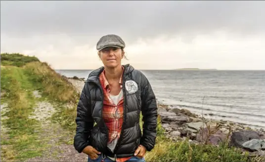  ?? ROBERT SMITH, NYT ?? Dianne Whelan, a documentar­ian and adventurer, on the shore of Bras d’Or Lake on Cape Breton Island in Canada.