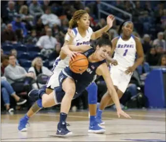  ?? CHARLES REX ARBOGAST — THE ASSOCIATED PRESS ?? Connecticu­t’s Kia Nurse, front, is tripped by DePaul’s Mart’e Grays during the first half Friday in Chicago.