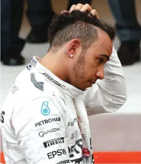  ?? Photo: AP ?? A disappoint­ed Lewis Hamilton touches his head at the end of the Monaco Grand Prix