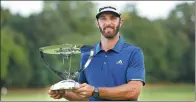  ?? ADAM HUNGER / AP ?? Dustin Johnson poses with the trophy after beating Jordan Spieth in Sunday’s playoff to win The Northern Trust in Old Westbury, New York.