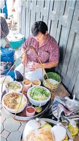  ??  ?? QUALITY: Right, a vendor offering ‘khanom jeen sao nam’ in front of the government clinic in Phetchabur­i City. Customers sit at tables set right in front and the place has an atmosphere all its own.