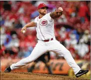  ?? GARY LANDERS / AP ?? Reds reliever Barrett Astin faced only two batters in his MLB debut Monday. He induced a ground out and a fly out to escape a two-on-and-one-out situation.