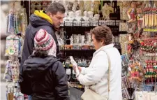  ?? AP ?? Fighting to preserve: A vendor sells souvenirs of Michelange­lo’s 16th century statue of David at a kiosk in Italy.