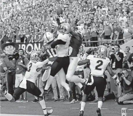  ?? Nati Harnik, The Associated Press ?? Colorado defensive backs Ronnie Blackmon, right, and Derrion Rakestraw watch as teammate Dante Wigley breaks up a pass that Nebraska’s JD Spielman, left, and Stanley Morgan jump for on the last play of Saturday’s game.