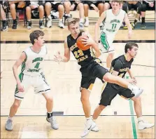  ?? J. PERENIC/DISPATCH] [BARBARA ?? Dane Goodwin, who had 39 points for Upper Arlington, grabs a rebound away from Trevor Grady of Dublin Coffman.